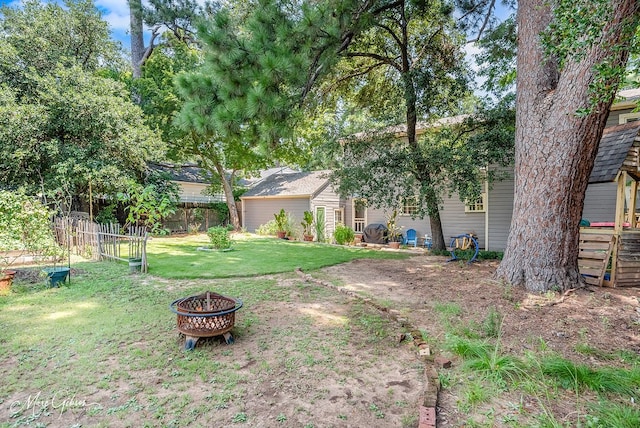 view of yard with an outdoor fire pit