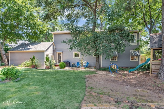 rear view of house with a yard