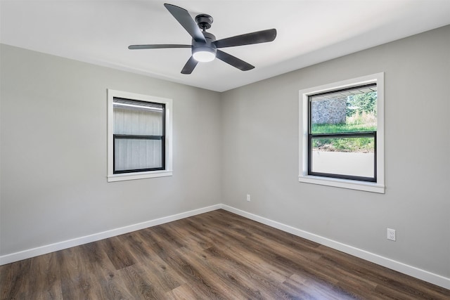 spare room with dark hardwood / wood-style floors and ceiling fan