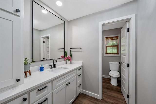 bathroom featuring hardwood / wood-style flooring, vanity, and toilet