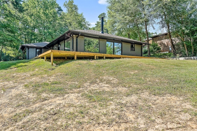 rear view of house with a lawn