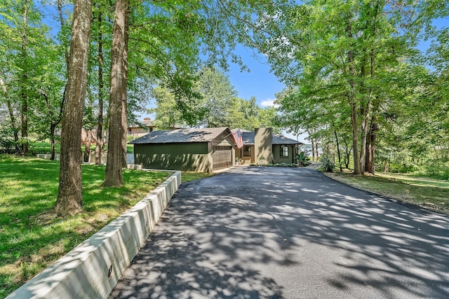 view of front of property with a garage and a front lawn