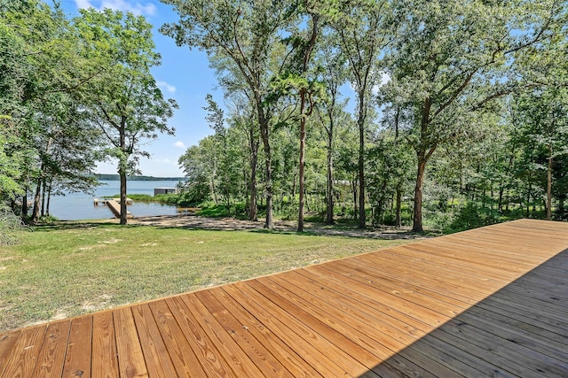 wooden terrace featuring a yard and a water view