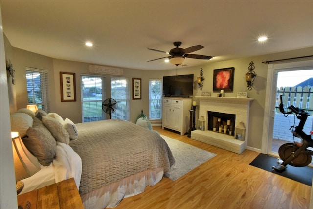 bedroom with access to outside, light hardwood / wood-style floors, and ceiling fan