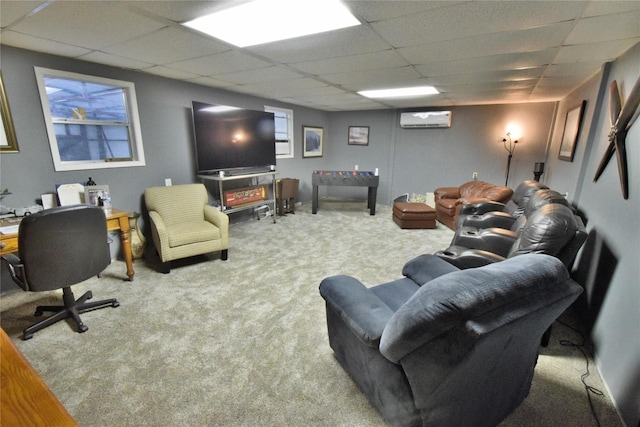 living room featuring carpet floors, a drop ceiling, and an AC wall unit