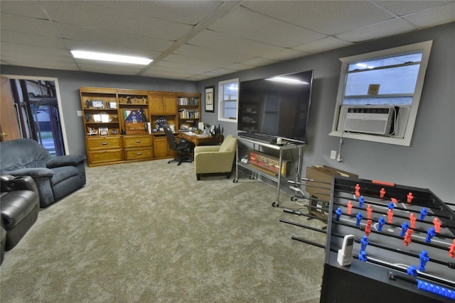 carpeted living room with cooling unit and a drop ceiling