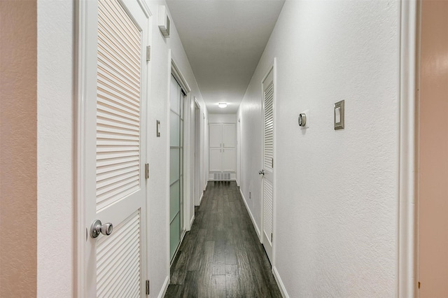 corridor featuring dark hardwood / wood-style flooring