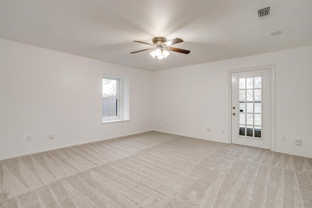 empty room featuring light carpet and ceiling fan