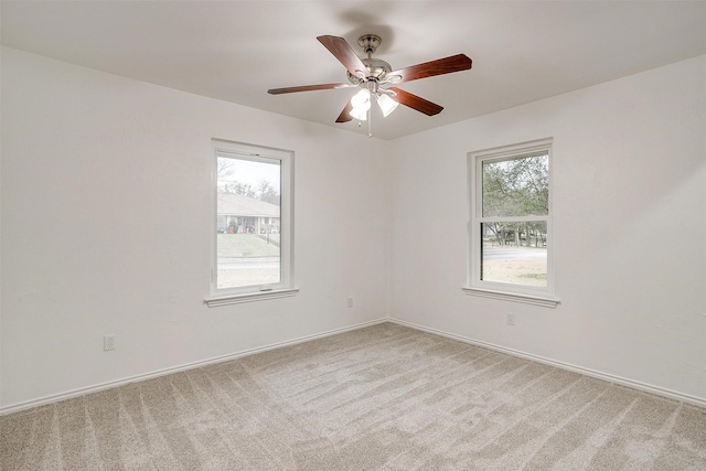 carpeted spare room with ceiling fan