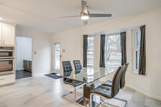 dining space featuring ceiling fan and light hardwood / wood-style flooring