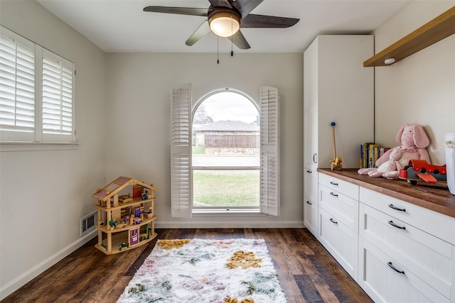 recreation room with dark hardwood / wood-style flooring and ceiling fan