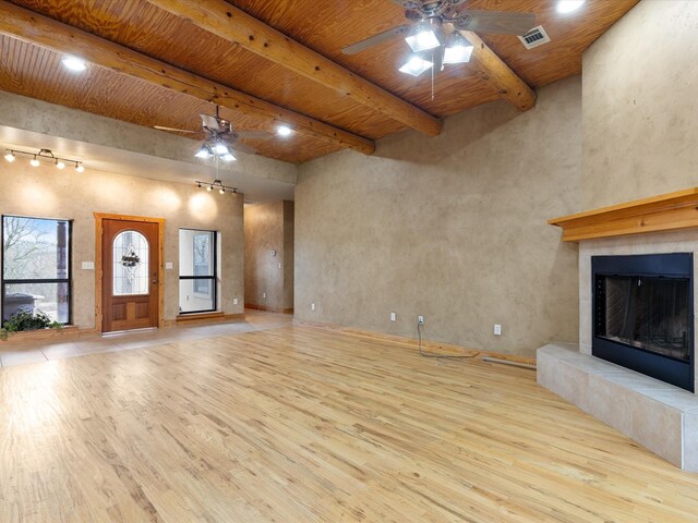 unfurnished living room with ceiling fan, wood finished floors, and wooden ceiling