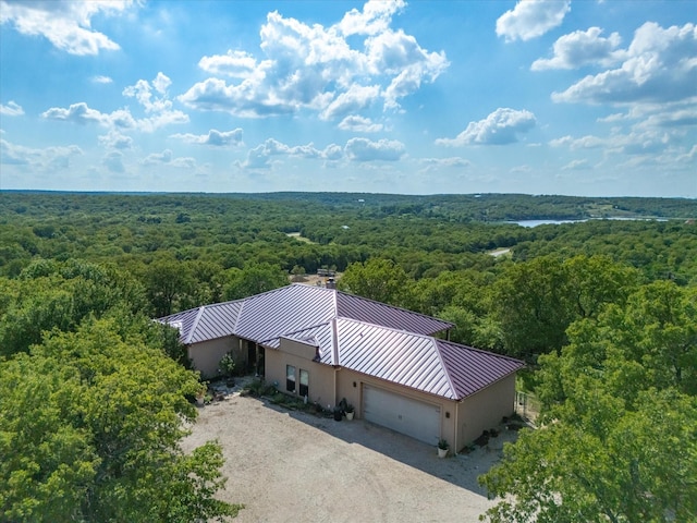 drone / aerial view featuring a wooded view