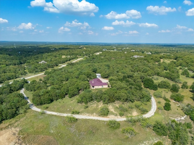 bird's eye view featuring a wooded view