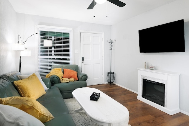 living room with a fireplace, ceiling fan, and dark hardwood / wood-style floors