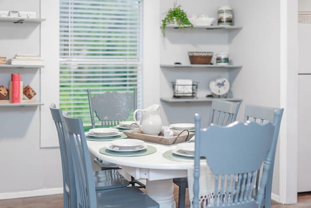 dining space featuring dark wood-type flooring