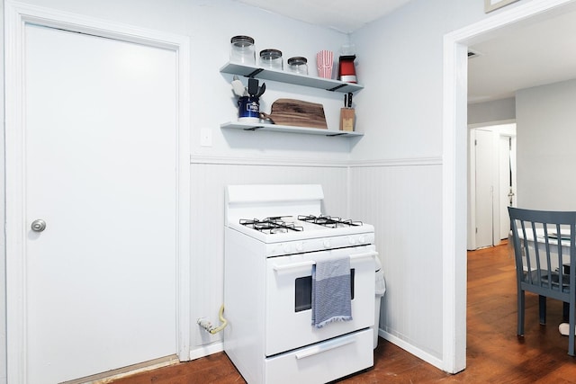 kitchen featuring white range with gas cooktop and dark wood-type flooring