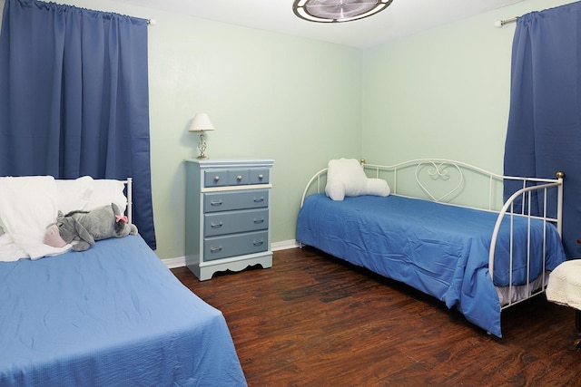 bedroom with dark wood-type flooring