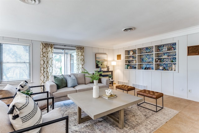 living room with crown molding, light tile patterned floors, and built in features