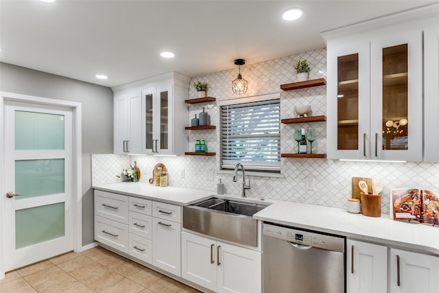 kitchen featuring hanging light fixtures, dishwasher, sink, and white cabinets