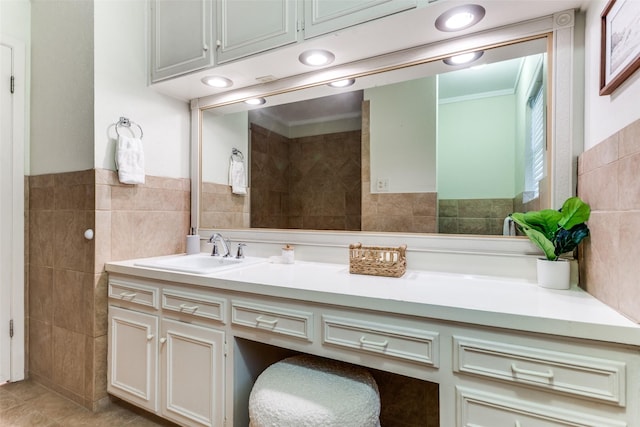 bathroom featuring tile walls, vanity, tile patterned flooring, and ornamental molding