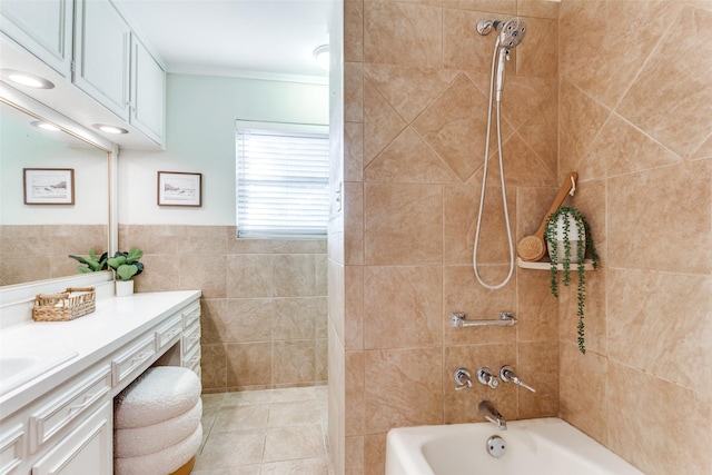 bathroom with tiled shower / bath, vanity, tile walls, and ornamental molding