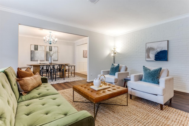 living room with hardwood / wood-style flooring, ornamental molding, and brick wall