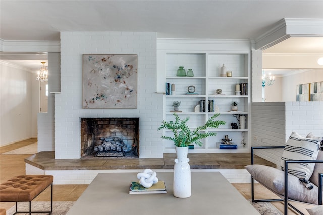 living room with crown molding, a fireplace, and an inviting chandelier