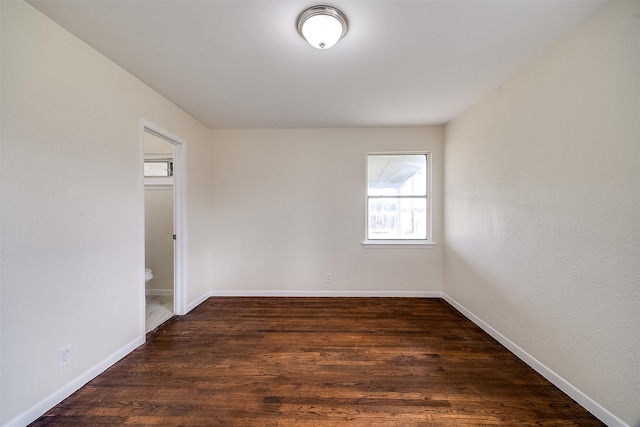 unfurnished room featuring dark hardwood / wood-style flooring