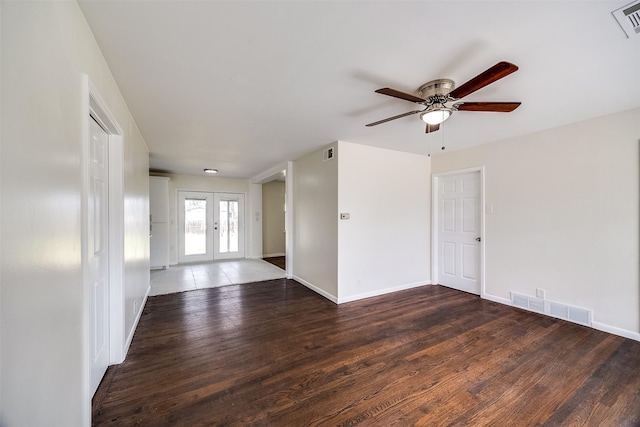 empty room featuring french doors, ceiling fan, and dark hardwood / wood-style floors