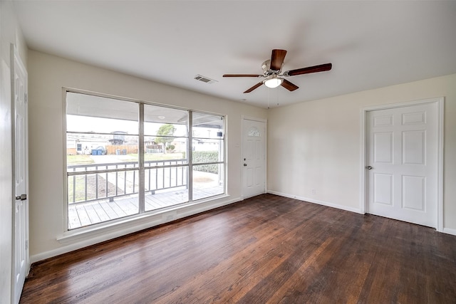 empty room with dark hardwood / wood-style floors and ceiling fan