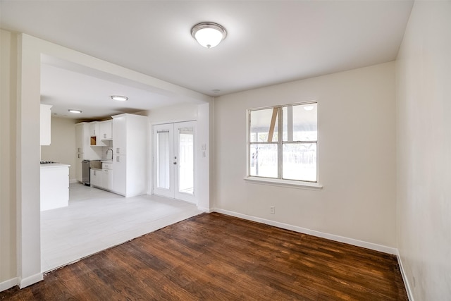 unfurnished room featuring dark hardwood / wood-style flooring and french doors