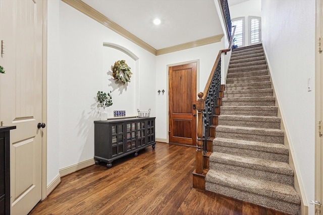 stairway with hardwood / wood-style floors and crown molding