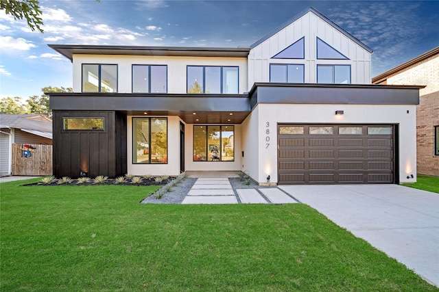 view of front facade featuring stucco siding, driveway, board and batten siding, and a front lawn