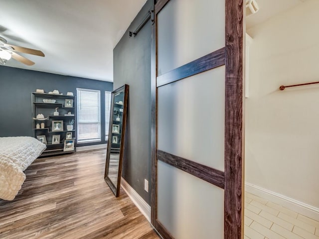 bedroom with hardwood / wood-style flooring and ceiling fan