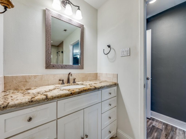 bathroom with hardwood / wood-style flooring and vanity