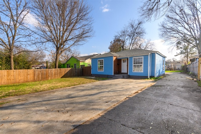 bungalow-style home featuring fence