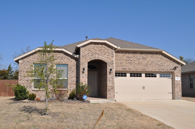 view of front of house featuring a garage and a front yard