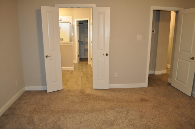 unfurnished bedroom featuring light colored carpet