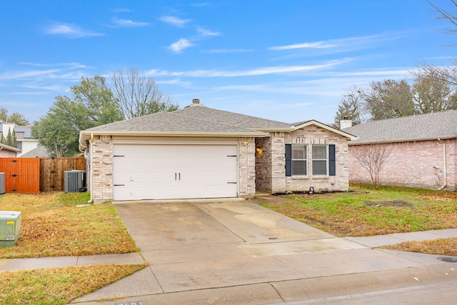 ranch-style home with a garage, a front yard, and central air condition unit