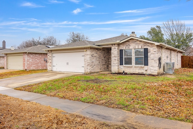 ranch-style house featuring a garage, a front lawn, and central air condition unit