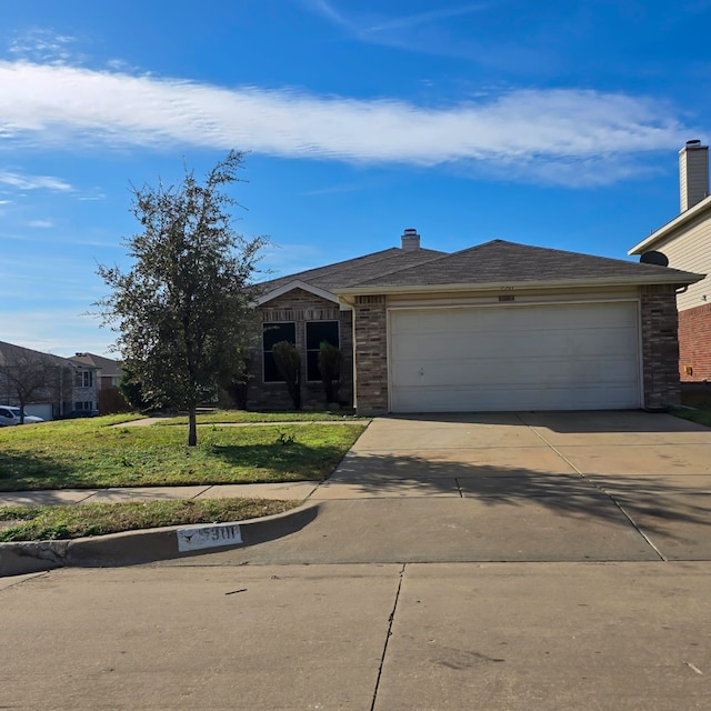 view of front of property with a front yard, concrete driveway, and an attached garage