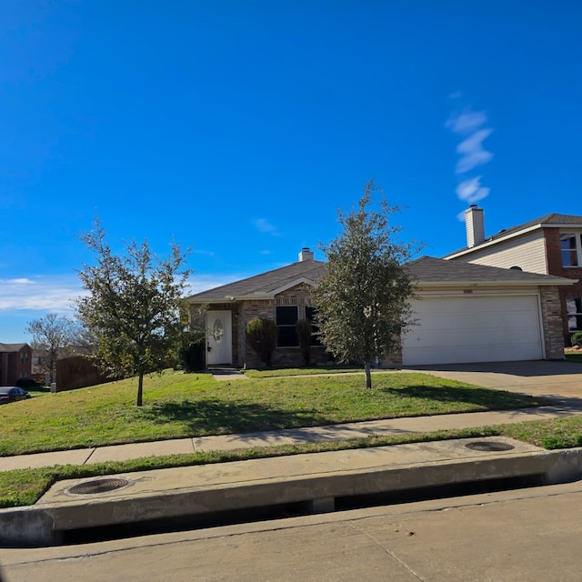 view of front facade with concrete driveway, a front lawn, and an attached garage