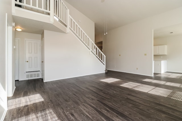 unfurnished living room featuring dark wood-type flooring