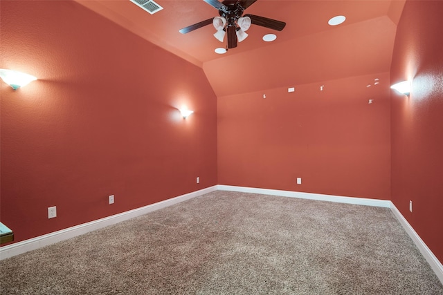 spare room featuring lofted ceiling, carpet floors, and ceiling fan