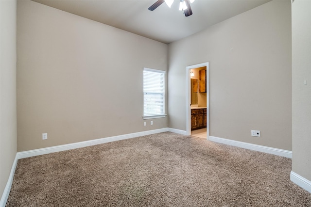 spare room featuring light colored carpet and ceiling fan