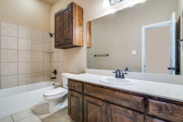 full bathroom featuring tiled shower / bath, vanity, toilet, and tile patterned flooring