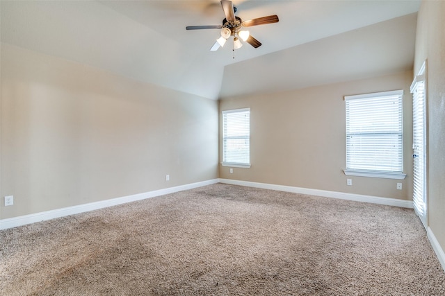 carpeted empty room featuring lofted ceiling and ceiling fan