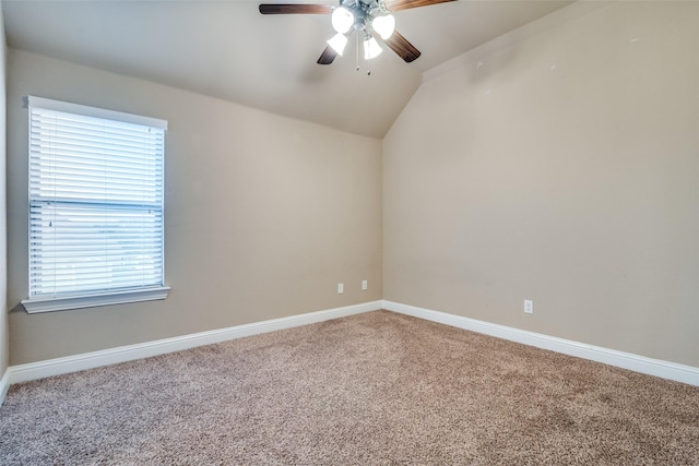 spare room featuring lofted ceiling, carpet floors, and ceiling fan