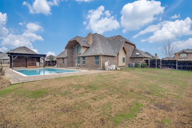 view of swimming pool with a gazebo, a yard, central AC unit, and a patio area